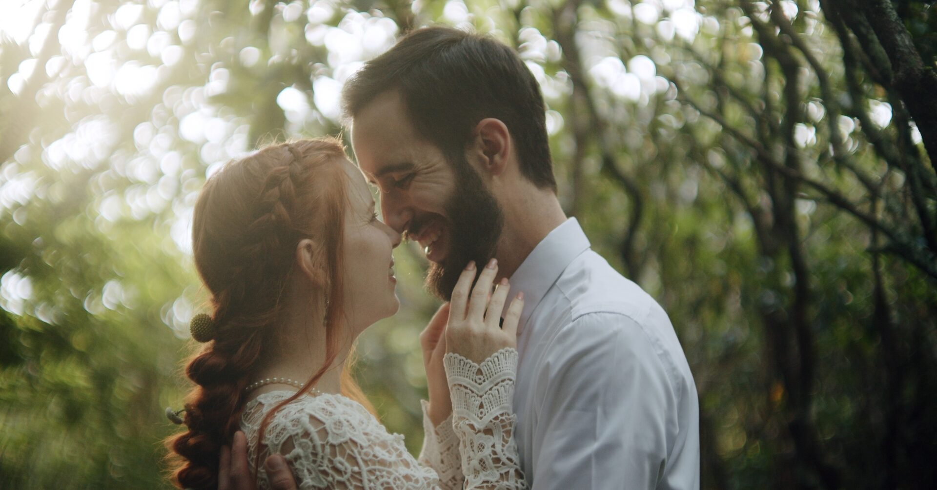 Bride and groom, smiling, hugging during their wedding